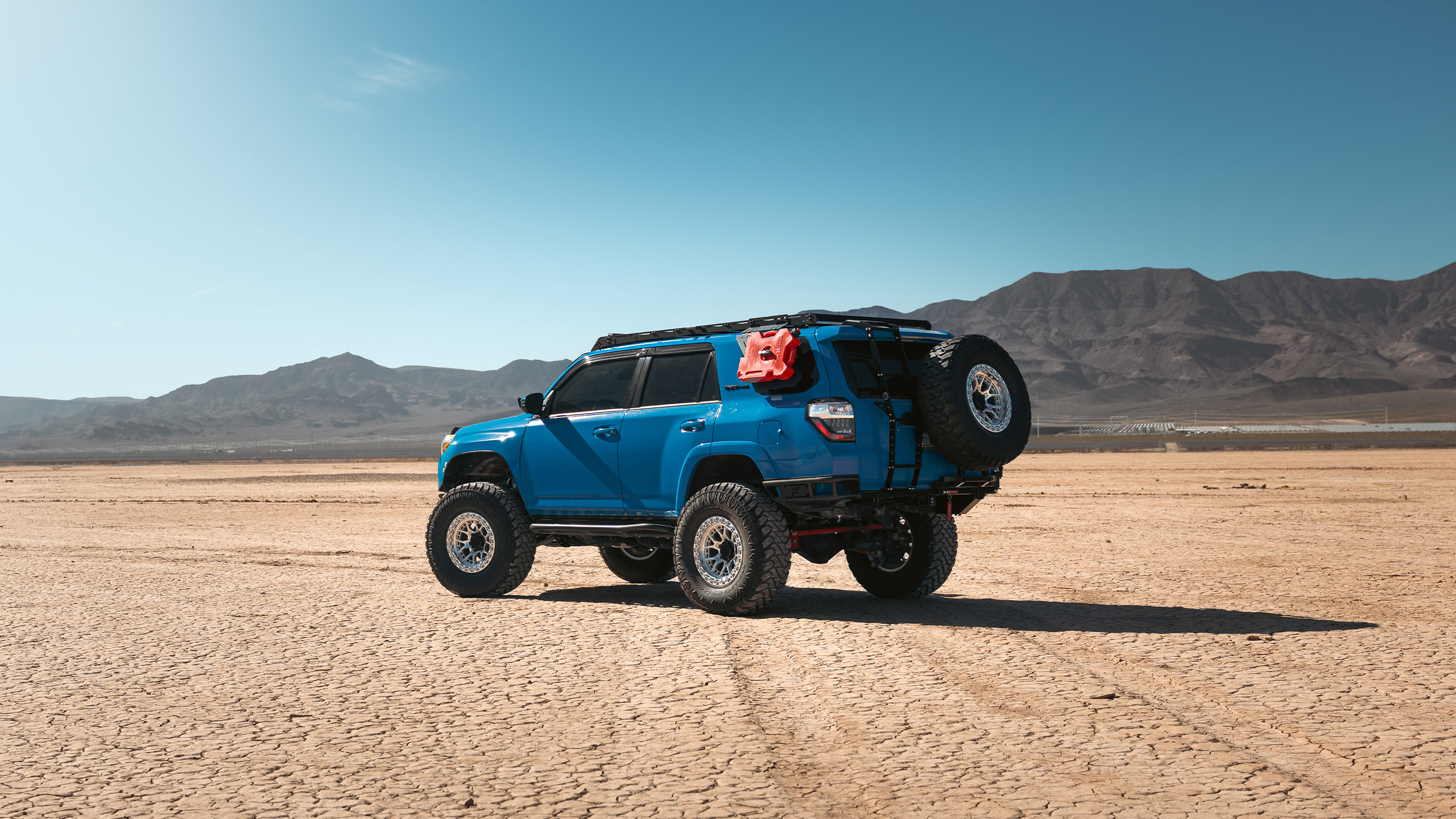 blue toyota 4runner on dry lakebed in nevada
