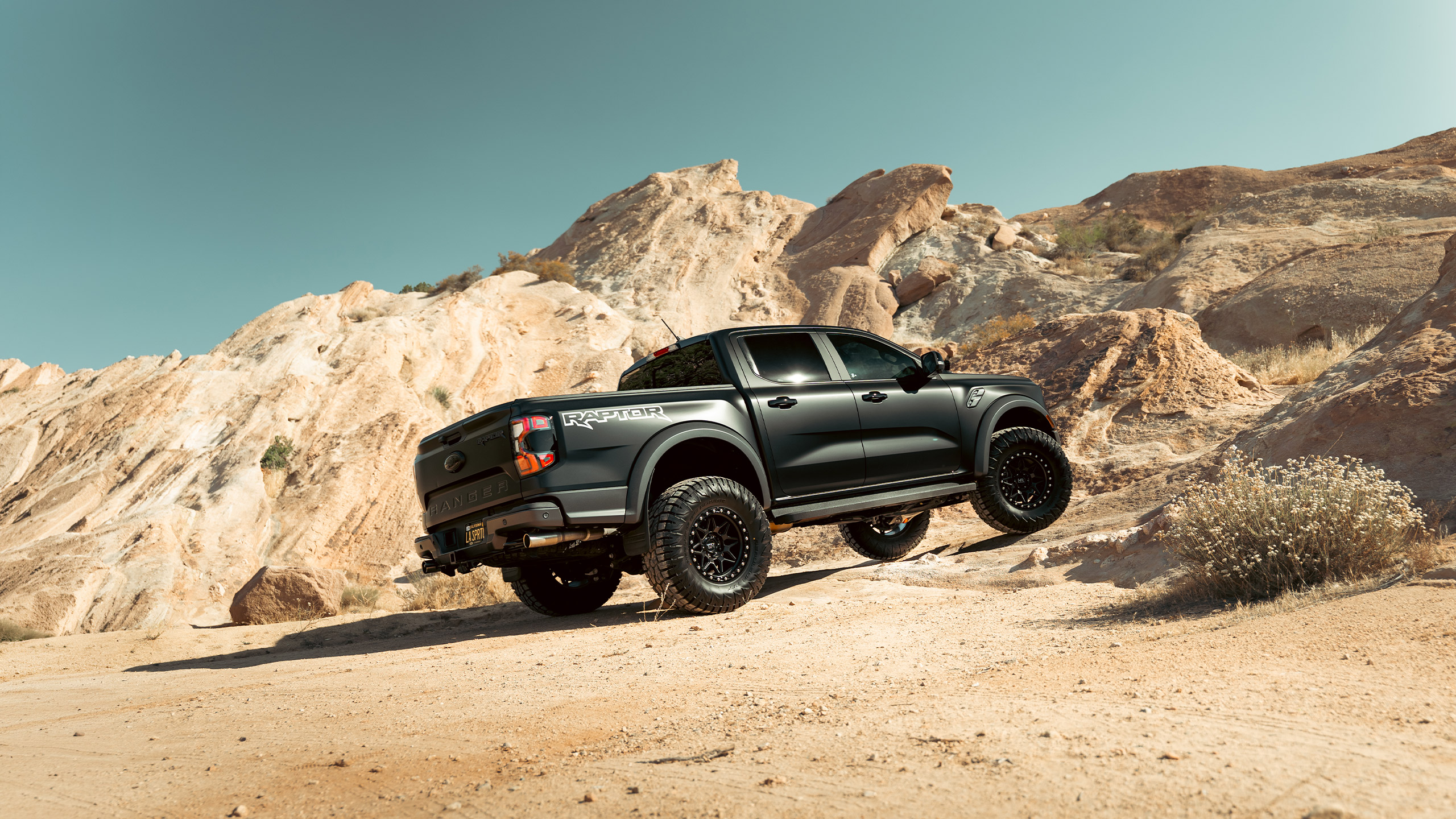 matte black ford ranger flexing in desert