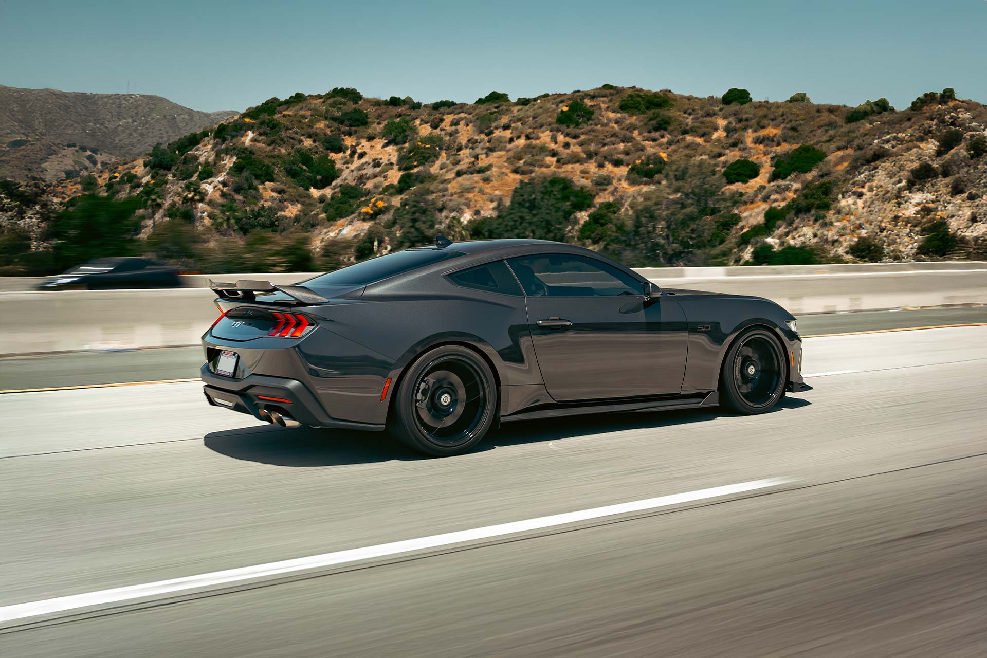 gray ford mustang gt s650 rolling on highway with lionhart tires