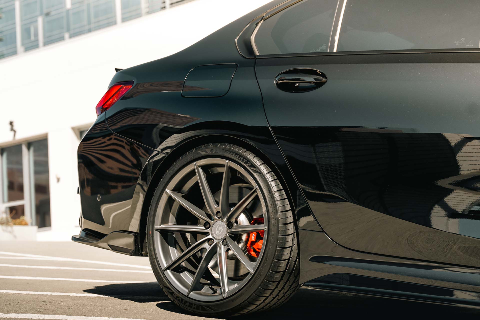 black bmw m340i with custom wheels and lionhart tires