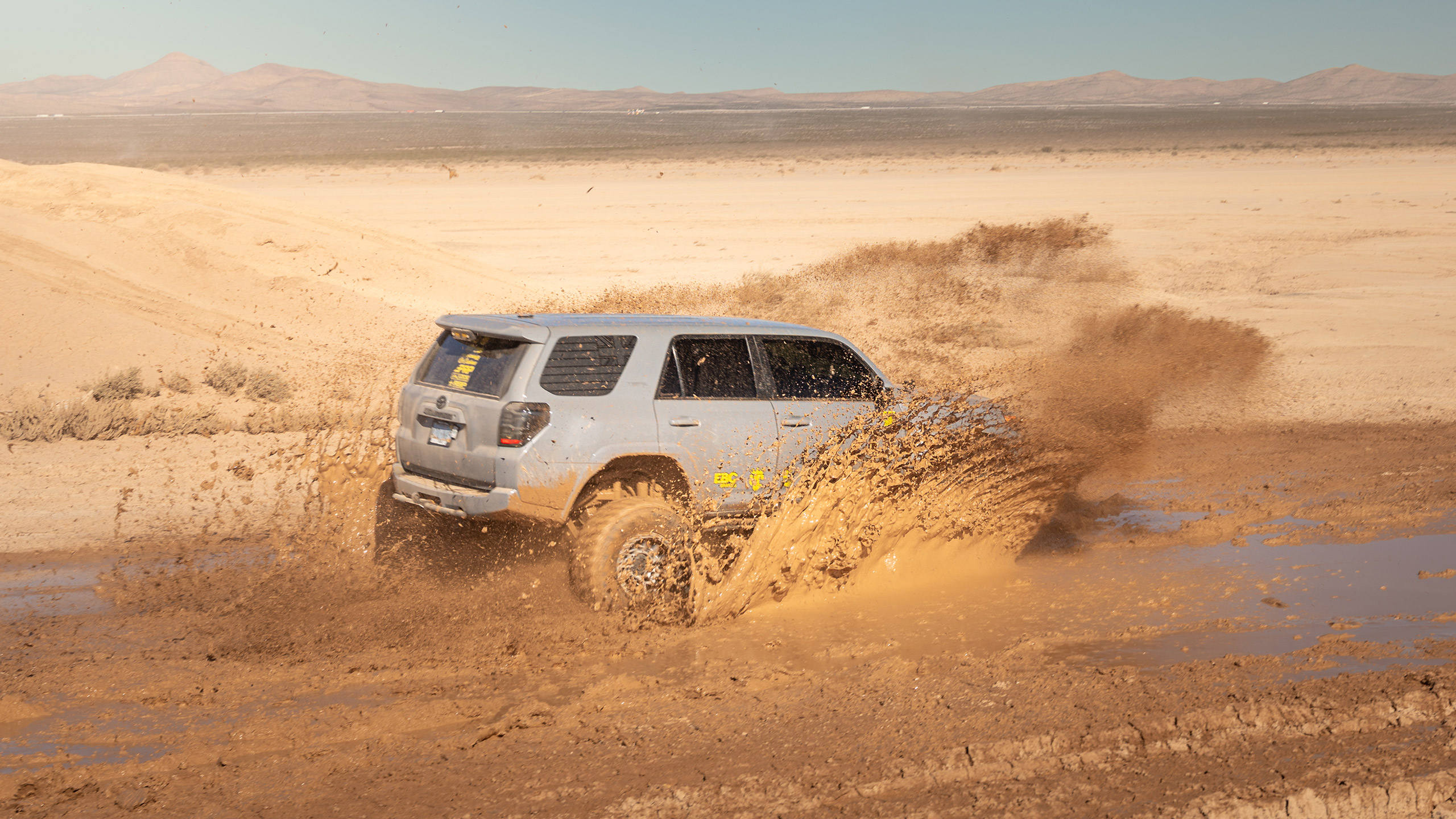 cement toyota 4runner splashing mud in the desert