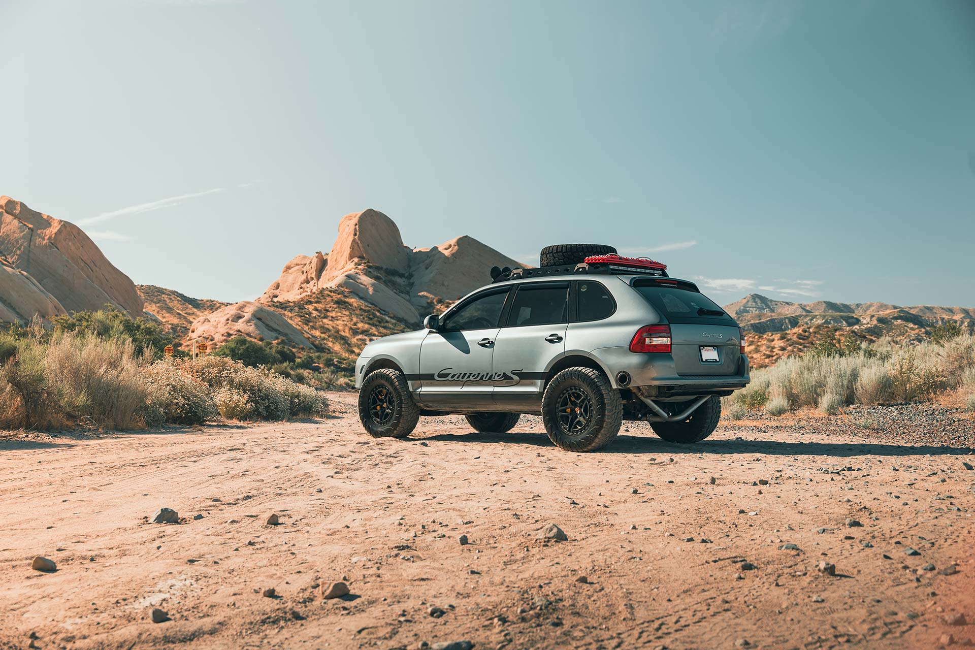 silver porsche cayenne s with rbp tires in desert landscape