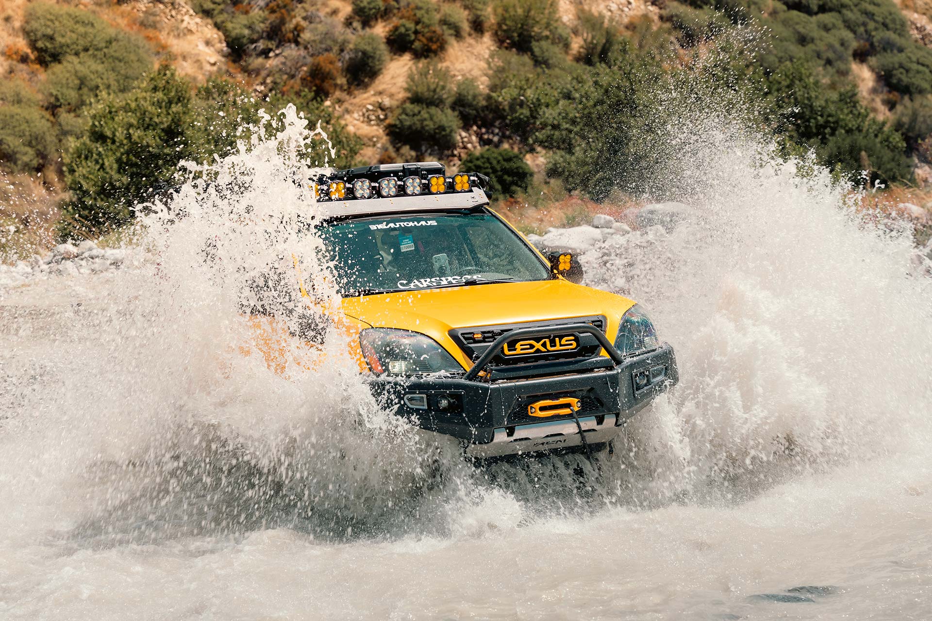 yellow lexus gx with rbp tires driving through running water