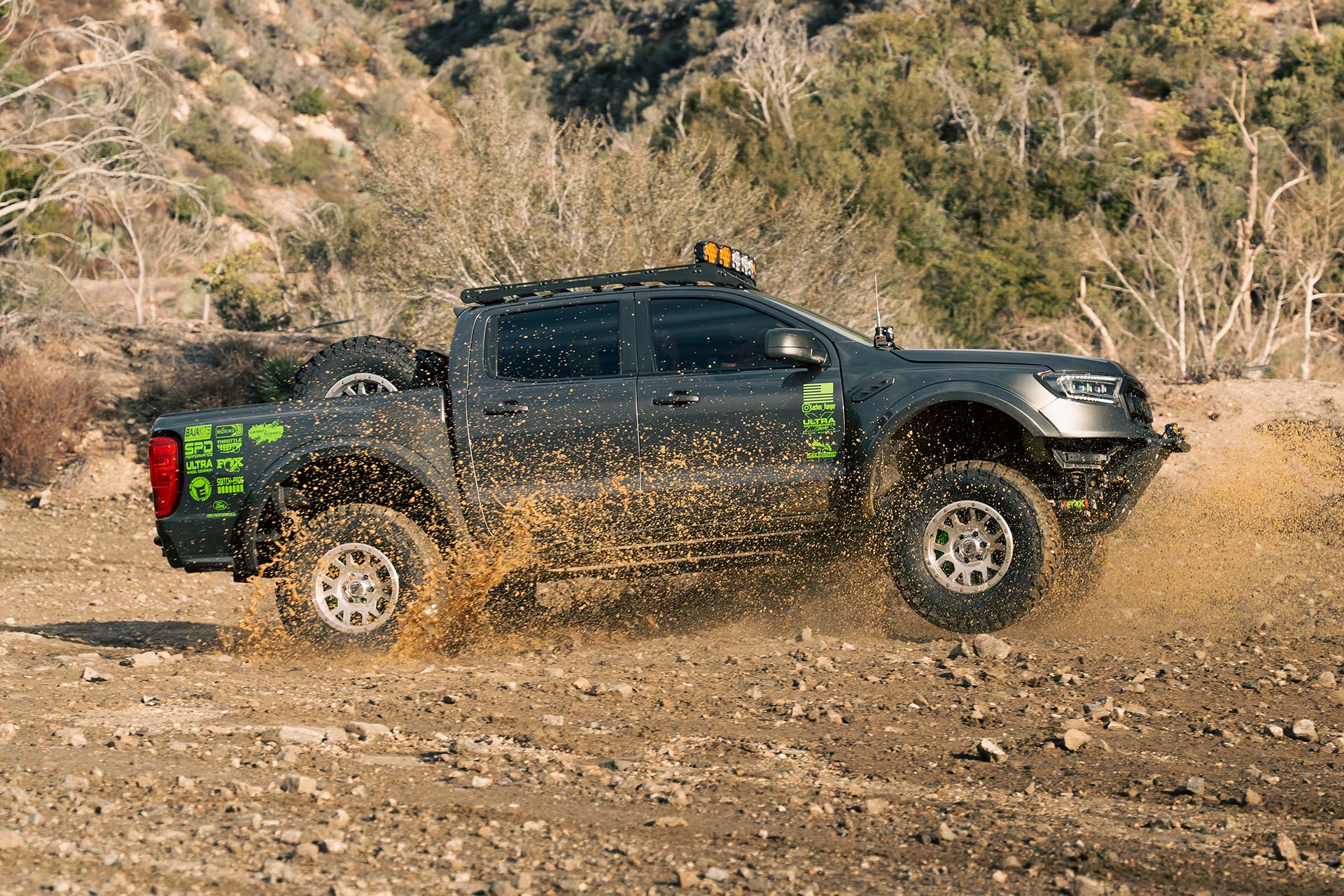 gray ford ranger with rbp tires driving through heavy mud