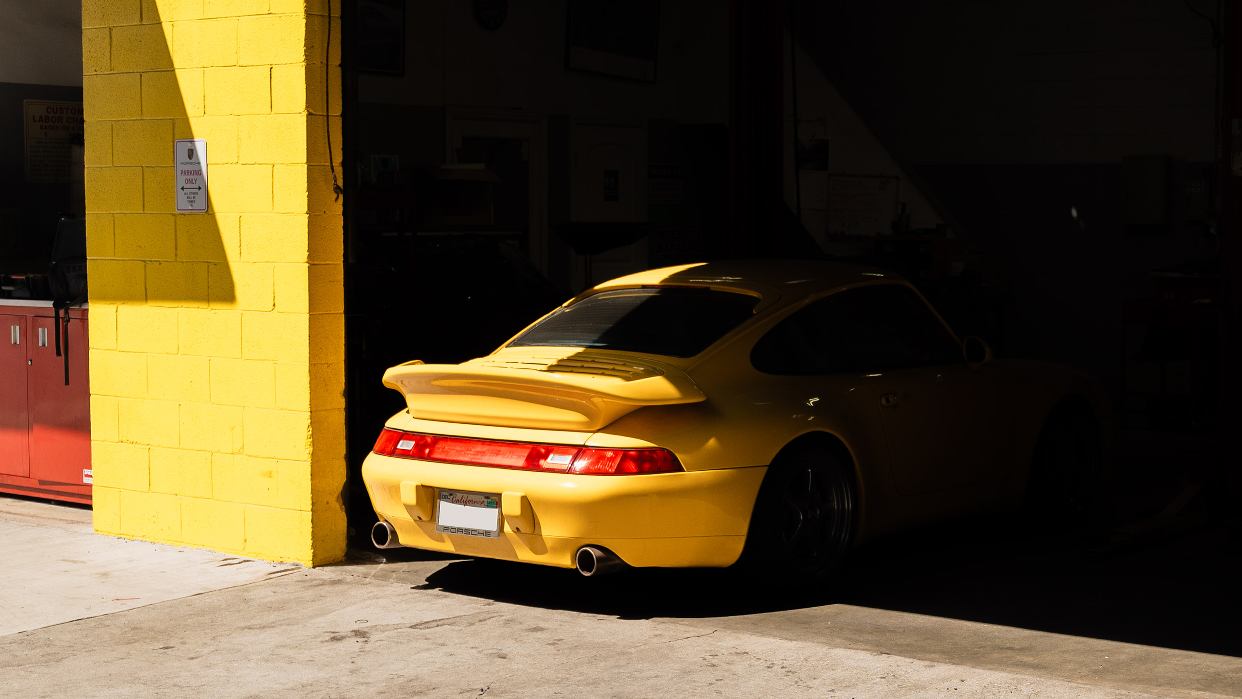yellow 993 911 at house automotive shop
